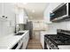 Bright updated kitchen with white subway tile, quartz counters, stainless appliances, and wood-look flooring at 3021 N Randolph Rd, Phoenix, AZ 85014