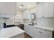 Modern kitchen features white cabinets, quartz countertops, stainless appliances and wood look floors at 3021 N Randolph Rd, Phoenix, AZ 85014