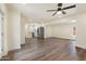 Spacious living room flows into modern kitchen, featuring stainless steel appliances and wood flooring at 3021 N Randolph Rd, Phoenix, AZ 85014