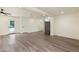 A large open-plan living room with recessed lighting, an exit door, and stainless refrigerator at 3021 N Randolph Rd, Phoenix, AZ 85014