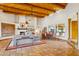 Bright and airy living room featuring exposed beams, a fireplace, and tile floors at 30600 N Pima Rd # 38, Scottsdale, AZ 85266