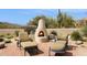 Inviting outdoor fireplace with comfortable seating and desert landscaping at 30600 N Pima Rd # 38, Scottsdale, AZ 85266