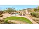 Expansive backyard offers a pool with rock features, outdoor fireplace and lush landscaping at 30600 N Pima Rd # 38, Scottsdale, AZ 85266