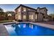 Inviting backyard showcasing a sparkling blue pool, lush lawn, and a putting green at 3737 E Donald Dr, Phoenix, AZ 85050
