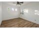 Empty bedroom with neutral walls, wood-look floors and many windows at 3737 E Donald Dr, Phoenix, AZ 85050