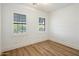 Empty bedroom with hard floors and two windows at 3737 E Donald Dr, Phoenix, AZ 85050