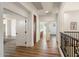 Upstairs hallway with white walls, wood-look floors, and access to various rooms at 3737 E Donald Dr, Phoenix, AZ 85050