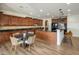 Spacious kitchen features dark cabinets, granite countertops, an island with seating, and a dining area at 3737 E Donald Dr, Phoenix, AZ 85050