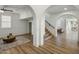 Open-concept living room featuring wood floors, white trim and staircase at 3737 E Donald Dr, Phoenix, AZ 85050