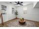 Cozy and inviting living room featuring wood floors, a ceiling fan, and neutral tones at 3737 E Donald Dr, Phoenix, AZ 85050
