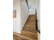 Staircase with wood steps, black railing, and natural light from the nearby window at 3737 E Donald Dr, Phoenix, AZ 85050