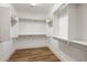 Spacious walk-in closet with shelving and wood-look flooring at 3737 E Donald Dr, Phoenix, AZ 85050