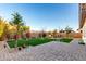 Spacious backyard with a fire pit area, lush artificial grass, and a paver patio, perfect for outdoor entertaining at 3739 S 180Th Dr, Goodyear, AZ 85338