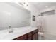 Full bathroom with a shower-tub combo, dark wood vanity, and a framed piece of art at 3739 S 180Th Dr, Goodyear, AZ 85338