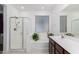 Bright bathroom featuring a glass-enclosed shower, bathtub with a window, and a modern vanity at 3739 S 180Th Dr, Goodyear, AZ 85338