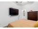Bedroom with ceiling fan, a mounted television, and dresser at 3739 S 180Th Dr, Goodyear, AZ 85338