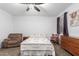 Inviting bedroom with a ceiling fan, comfortable armchair, and a window providing natural light at 3739 S 180Th Dr, Goodyear, AZ 85338