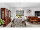 Elegant dining room features a round table, upholstered chairs, a chandelier and a decorative cabinet at 3739 S 180Th Dr, Goodyear, AZ 85338