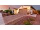 Beautiful home with a brick driveway, mature landscaping, and a spacious two-car garage at 3739 S 180Th Dr, Goodyear, AZ 85338