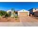 Inviting single-story home boasting a brick driveway, lush landscaping, and an attached two-car garage at 3739 S 180Th Dr, Goodyear, AZ 85338