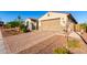 Attractive home with brick driveway, beautifully landscaped yard, and a convenient two-car garage at 3739 S 180Th Dr, Goodyear, AZ 85338