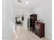 Bright hallway with neutral tile flooring, white walls, and decorative shelving at 3739 S 180Th Dr, Goodyear, AZ 85338
