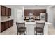 Stylish kitchen with stainless steel appliances, breakfast bar seating, and sleek countertops at 3739 S 180Th Dr, Goodyear, AZ 85338