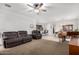 Bright and airy living room with a ceiling fan, comfortable seating, and open floor plan that flows into the kitchen at 3739 S 180Th Dr, Goodyear, AZ 85338