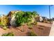 Well-kept yard with desert landscaping and mature trees in a peaceful neighborhood at 3739 S 180Th Dr, Goodyear, AZ 85338