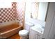 Bathroom with orange tiled shower and floor, toilet, and vanity at 3822 N 48Th Dr, Phoenix, AZ 85031