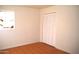 Bedroom with painted brick walls, a window and closet with folding doors at 3822 N 48Th Dr, Phoenix, AZ 85031