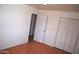 Bedroom featuring tile flooring, closet with folding doors and two entry doors at 3822 N 48Th Dr, Phoenix, AZ 85031