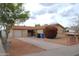 Tan single-story home featuring a brick front entryway, and a two-car garage at 3822 N 48Th Dr, Phoenix, AZ 85031