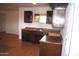 Kitchen featuring dark wood cabinets, tile flooring, and a stainless steel sink at 3822 N 48Th Dr, Phoenix, AZ 85031