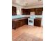 Traditional kitchen featuring brown cabinets, and tile flooring at 3822 N 48Th Dr, Phoenix, AZ 85031