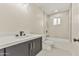 Modern bathroom features sleek vanity, toilet, and a tub-shower combo with neutral tile surround at 4055 E Catalina Cir, Mesa, AZ 85206