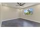 Well-lit bedroom with a ceiling fan, neutral walls, and a view of the exterior yard at 4055 E Catalina Cir, Mesa, AZ 85206