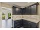 Stylish butler's pantry boasts sleek cabinetry, designer hardware, and quartz countertops at 4055 E Catalina Cir, Mesa, AZ 85206