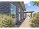Charming exterior view of home featuring flower bushes, a covered patio, and large picture windows at 4055 E Catalina Cir, Mesa, AZ 85206