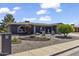 Landscaped front yard featuring a manicured tree, attractive plantings, and brick accents at 4055 E Catalina Cir, Mesa, AZ 85206
