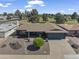 Charming single-story home featuring a well-manicured front yard and an attached two-car garage at 4055 E Catalina Cir, Mesa, AZ 85206