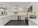 Modern kitchen featuring white cabinets, quartz countertops, and stainless steel appliances at 4055 E Catalina Cir, Mesa, AZ 85206