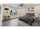 Comfortable main bedroom features an arched window, ceiling fan, and neutral color palette at 4055 E Catalina Cir, Mesa, AZ 85206