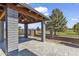 Covered patio with stone columns and ceiling fan overlooking the manicured backyard and landscaping at 4055 E Catalina Cir, Mesa, AZ 85206