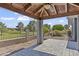Covered patio with stone columns and ceiling fan overlooking the manicured backyard and landscaping at 4055 E Catalina Cir, Mesa, AZ 85206