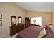 Warm bedroom featuring a dresser with dual mirrors, a lamp, and a TV at 416 Leisure World --, Mesa, AZ 85206