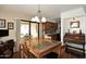 Charming dining room featuring wood floors, a large table, and sliding glass doors to patio at 416 Leisure World --, Mesa, AZ 85206