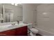 Bathroom featuring a vanity with cherry wood cabinets, tub, shower, and toilet at 4289 E Jasper Dr, Gilbert, AZ 85296
