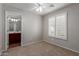 A cozy bedroom featuring neutral walls, carpet floors, and a window with white shutters at 4289 E Jasper Dr, Gilbert, AZ 85296