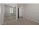 Bedroom featuring neutral walls, carpet, closet with mirrored doors, and view to bathroom at 4289 E Jasper Dr, Gilbert, AZ 85296